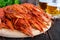 A pile of large crawfish on a wooden tray, glasses with beer