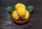 Pile lemon in bowl on wood background