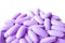 Pile of Lilac purple color oval shaped supplement pills