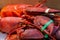 Pile of live lobsters on ice in a seafood market