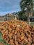 Pile of loose red bricks stacked on ground at construction site.