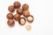 Pile macadamia nuts open kernels and shells on white background, top view