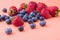 Pile of many fresh ripe fruits isolated on orange background.