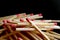 Pile of matchsticks on black background