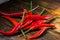 Pile of Mexican mini chili peppers on wooden background