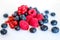 Pile of mixed berries on white background