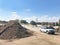 Pile of mixed soil with compost and enriched top soil wholesale with delivery trucks