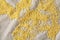Pile of natural organic millet on homespun tablecloth, top view, close-up, selective focus.