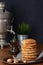 Pile Oatmeal Cookies with nuts and black tea at Samovar on a wooden table