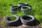 A pile of old car tires on a background of green grass