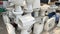 Pile of old and dirty damaged ceramic toilets at a used toilet dealer