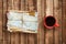 Pile of old envelopes and coffee cup on wooden table