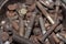 Pile of old rusty screw heads, bolts, metal nuts. Bolt used overlapping full. Bolts and screws used in constructions