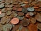 A pile of old, tarnished, corroded British copper coins