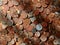 A pile of old, tarnished, corroded British copper coins