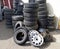 Pile of old tires and wheel rims near the workshop