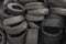 A pile of old used car tires to be recycled to new tires
