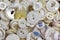 A pile of old white sewing buttons