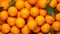 A pile of oranges with leaves