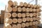 Pile of pine logs in a sawmill, close up.