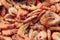 Pile of pink cooked shrimps at the fish market
