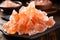 a pile of pink crystals on a black plate