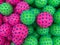 Pile of pink and green sensory balls or swimming float balls used as virus models demonstrating coronavirus wild type and variant