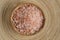 Pile of pink salt wooden background.