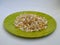 Pile of a Pongal Traditional Raw Mixtures of Ellu Bella in a Green Plate isolated on white Background