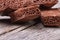 Pile of porous chocolate on old wooden table