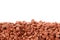 Pile of potassium chloride. Isolate. Close-up. Copy space. Potassium chloride is a red mineral fertilizer close-up. The texture of