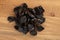 Pile of prunes, dry plums isolated on wood background