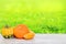 Pile of pumpkins. Close-up of a stack decorative colorful pumpkins on a bright wooden table against abstract blurred natural green