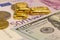 Pile of pure gold bars, bullion, ingot on background of banknotes of US dollar and Euro