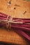 Pile of purple beetroot fettuccine pasta on wood, closeup