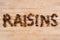 Pile of raisins arranged to make RAISINS word