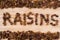 Pile of raisins arranged to make RAISINS word