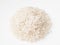 Pile of raw medium-grain polished rice on white