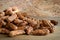 Pile raw peanuts in shell on wooden background
