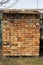 Pile of red bricks neatly folded on pallets. lot of brick for construction is covered from rain. Building material for walls,