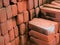 PILE OF RED CLAY BRICKS