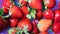 Pile of red vibrant strawberries in the basket