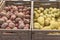 Pile of red and yellow potatoes variety in plastic crate at market stand in Houston, Texas, USA