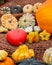 A pile of ripe decorative pumpkins at a harvest festival. Orange ripe pumpkin, striped zombie squash, still life vertical