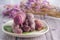 Pile of ripe purple yams is placed on a plate on a wooden table