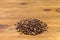 Pile of roasted artesanal gourmet coffee beans pattern on a wood table
