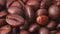 Pile of roasted coffee beans, close shot. Camera moving along heap of brown coffee beans, abstract background. Selective