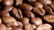 Pile of roasted coffee beans rotating. Close up