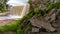 Pile of rocks in the foreground and a waterfall on the background