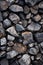 Pile of rocks with rusted metal object on top. Generative AI